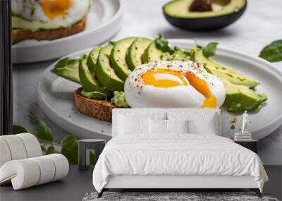 Poached eggs on avocado toast is a delicious breakfast dish featuring creamy avocado spread on toasted bread topped with perfectly poached eggs, providing a satisfying, nutritious meal. Wall mural