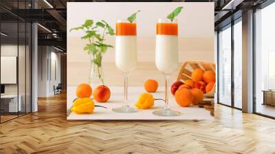 2 glass of Panna Cotta, traditional sweet italian dessert, with apricot jelly and touch of yellow hot habanero chilli, cinnamon, decorated with fresh mint. Wall mural