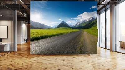 country road and green grass with mountain scenery under blue sky Wall mural