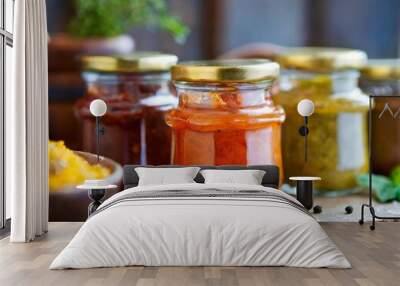 Rustic condiment jars with depth of field showcasing homemade relishes and chutneys Wall mural