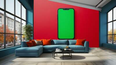 Black Smartphone with Green Screen on Red Background Wall mural