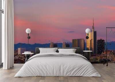 Milan skyline at sunset with modern skyscrapers in Porta Nuova business district in Italy. Panoramic view of Milano city. The mountain range of the Lombardy Alps in the background. Wall mural