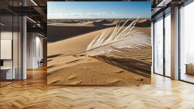 Feather blowing across the desert sand dunes under a bright sky Wall mural