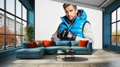 Man wearing puffer vest and gloves on plain white background Wall mural