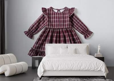 Small plaid dress for kid girls with ruffled hem on plain white background Wall mural