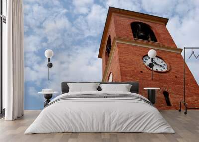 
red brick bell tower with clock on blue sky background Wall mural