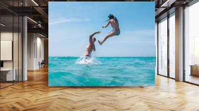 Couple having fun in the sea Wall mural