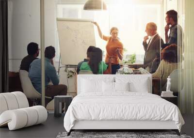 All hands are on deck for this meeting. Shot of a group of coworkers in a boardroom meeting. Wall mural