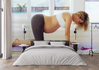 She understands the benefits of prenatal exercise. Full length shot of an attractive young pregnant woman on all fours on a yoga mat. Wall mural