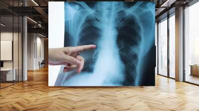 Woman doctor hands holding and point patient chest x-ray film .Image lung at radiology department in hospital.Covid-19 scan body xray test detection for covid virus epidemic spread concept. Wall mural