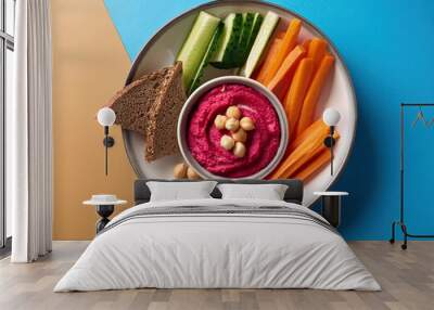 Beet hummus with chickpeas, carrots and cucumbers in a bowl on a colorful background Wall mural