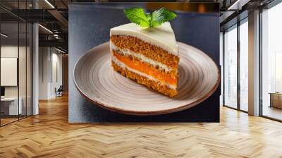 Carrot cake with cream cheese frosting decorated with mint leaves on plate Wall mural