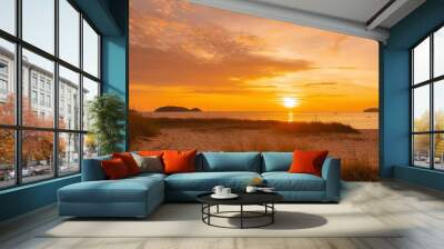 sunrise at the coast of the beach with summer yellow grass Wall mural