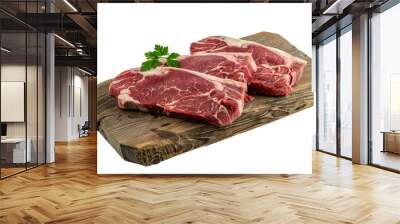 Three juicy raw steaks with a parsley garnish on a wooden board Wall mural