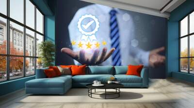 A businessman in white hold a 5 star quality certification mark, indicating the impressive and high quality of products and services. ISO 9001 quality assurance certified concept. Wall mural