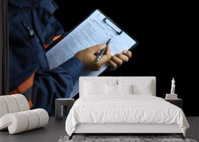 An auditor or inspector holds a clipboard and checklist of assessments and inspections on a black background. Wall mural