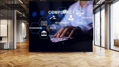 Compliance concept with businessman working with laptop to apply requirement for standard regulation to meet government trade on global business Wall mural