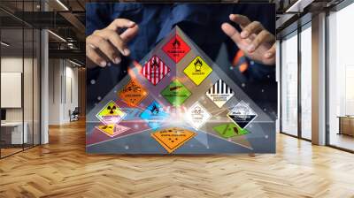 Hazardous substance concept chemical safety officer at a dangerous goods warehouse work through hologram to arrange warning sign for different chemical to separate area in sea and air cargo shipment Wall mural