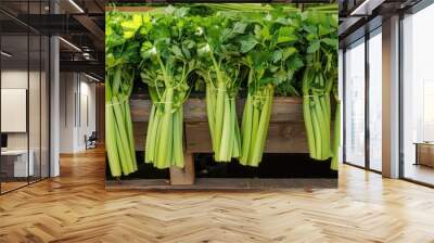 A bunch of celery is displayed on a wooden table Wall mural