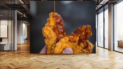 Fried chicken tenders drizzled with sauce Wall mural