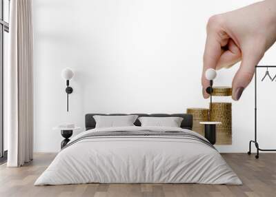 The girl puts coins a pyramid. Isolate on white Wall mural