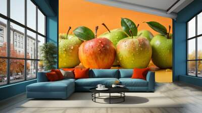 Fresh apples with water droplets glisten against vibrant orange background, showcasing mix of red and green varieties. scene evokes sense of freshness and vitality Wall mural