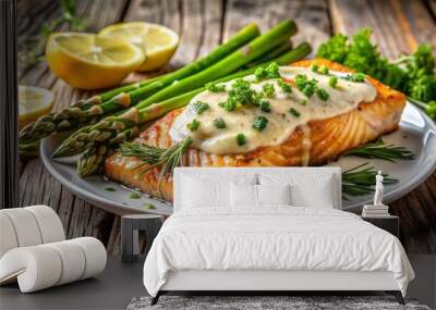 Freshly grilled salmon fillet paired with tender roasted asparagus spears, finished with a zesty and refreshing lemon dill sauce, on a rustic wooden background. Wall mural