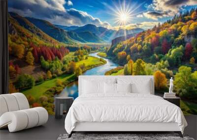 Valley comes alive with vibrant colors as river sparkles under radiant afternoon sunlight amidst lush vegetation. Wall mural