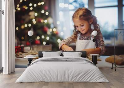 Cute little girl baking gingerbread cookies at home on Christmas eve Wall mural