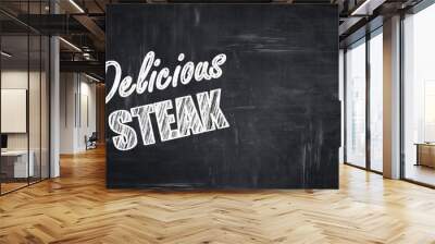 Chalkboard background with chalk letters: Delicious steak sign Wall mural