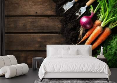 Freshly harvested carrots and an onion with gardening tools on dark wooden background, perfect for farm and organic produce concepts. Wall mural