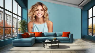 Blonde woman model wear a blue sundress isolated on pastel background Wall mural