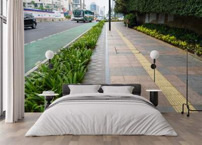 Jakarta, November 9, 2022. Pedestrian sidewalks with beautiful green decorative plants on one of the streets in Jakarta, Indonesia Wall mural