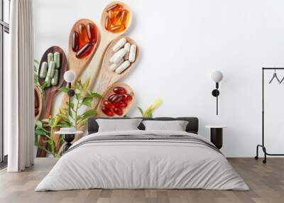 Wooden spoon with assorted herbal vegan vitamin capsules for healthy lifestyle with fresh leaves Wall mural