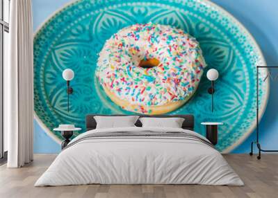 Delicious sprinkled white sweet donut - top view Wall mural