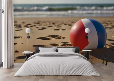 a colorful beach ball resting on soft, golden beach sand Wall mural