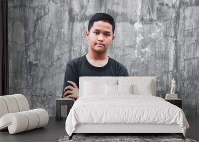 A young Hispanic man standing with a with a happy face smiling with crossed arms looking at the camera. positive person. Wall mural