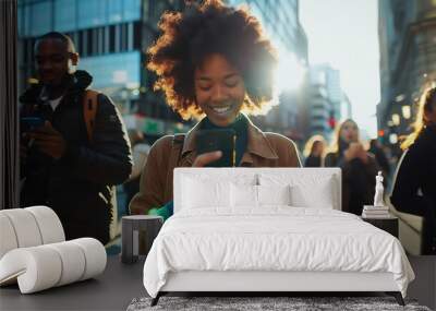 A Young Woman with Curly Hair Smiles at Her Phone While Walking Through the City Wall mural