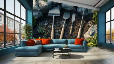 Four Garden Tools Resting Amongst Rocks and Plants Wall mural