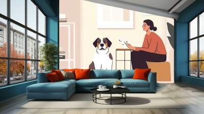 Woman Sitting on a Stool with Two Dogs in a Room Wall mural