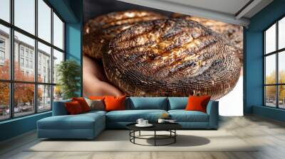 Close-up of Two Grilled Portobello Mushrooms Held by Hands Wall mural