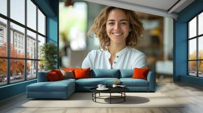 Portrait of a Smiling Woman with Curly Hair Wearing a White Shirt Wall mural