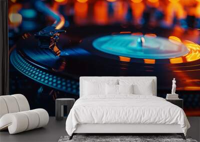 Vinyl record spinning on turntable illuminated by blue and orange lights Wall mural