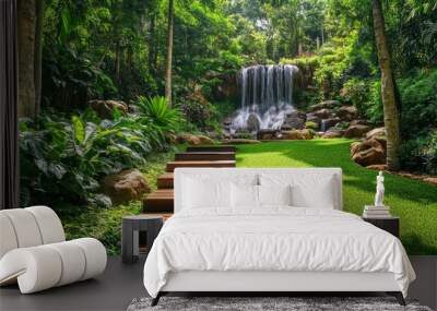 A lush green lawn with wooden stairs leading to the waterfall in Phuket, Thailand. Photo-realistic landscapes, colorful gardens.  Wall mural