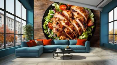 A plate of grilled chicken breast on a bed of lettuce, tomatoes and red onion. Wall mural