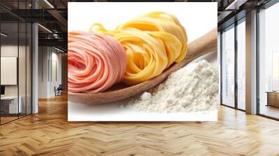 A wooden spoon holds two types of fresh pasta, one pink and one yellow, with a mound of flour in front of it. Wall mural