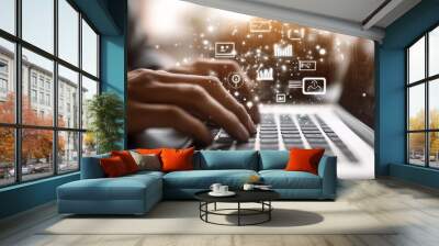 Close-up of hands typing on a laptop with digital project management icons floating above, technology in marketing using AI, white background, blurred foreground.  Wall mural