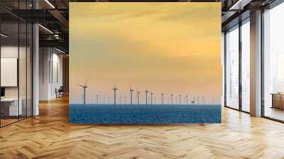 HORNSEA OFFSHORE WIND FARM, UK - 2016 JULY 15. The sun sets behind a coastal wind farm at Hornsea. Wall mural