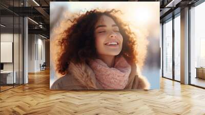 A brunette woman breathes calmly looking up enjoying winter season Wall mural