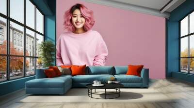 An Asian woman wearing pink sweatshirt isolated on pastel background Wall mural